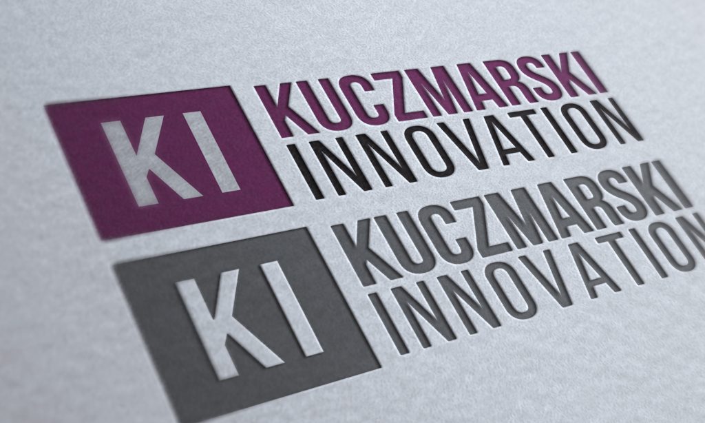 Mockup of the Kuczmarski Innovation logo in color and greyscale